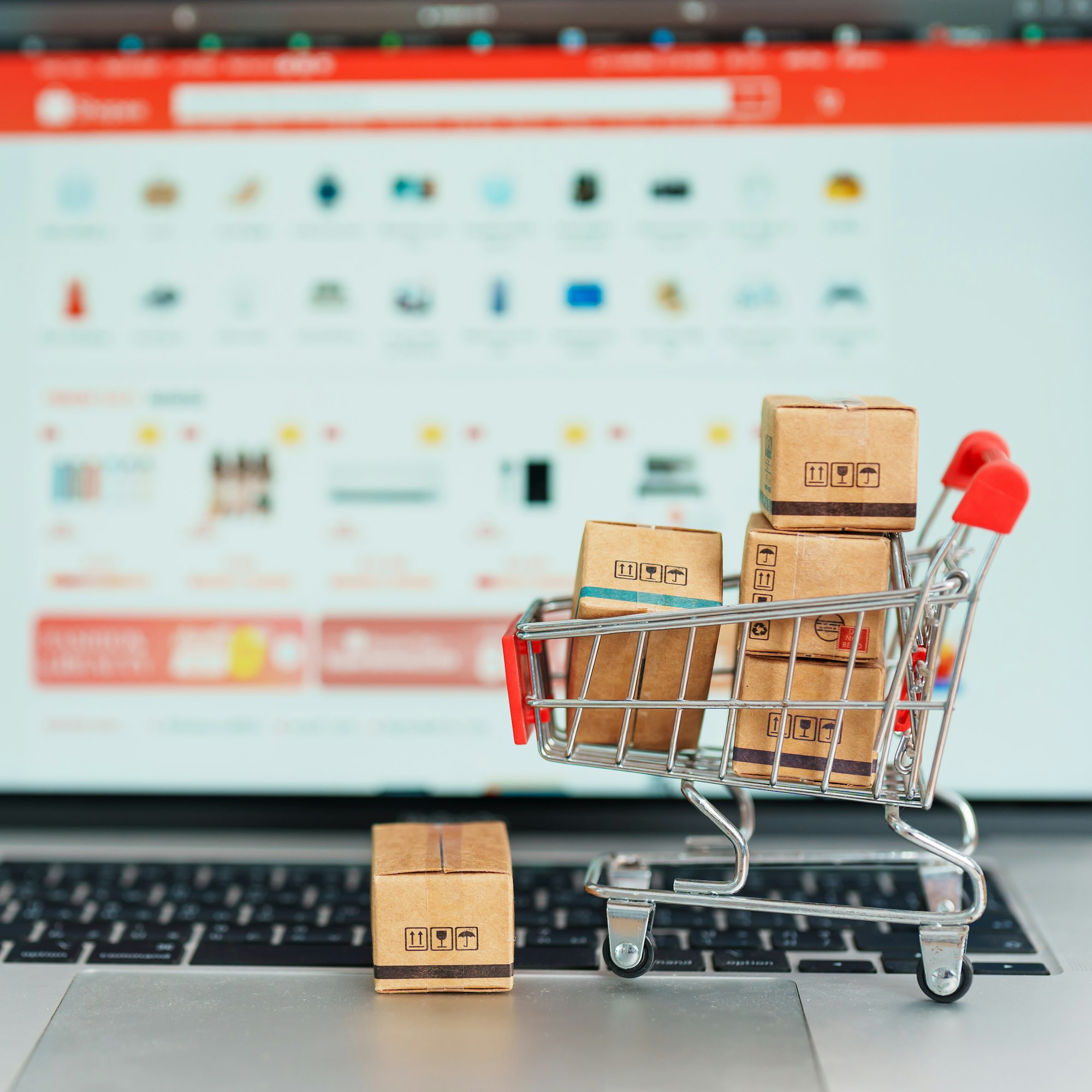 Boxes with shopping cart on a laptop computer.