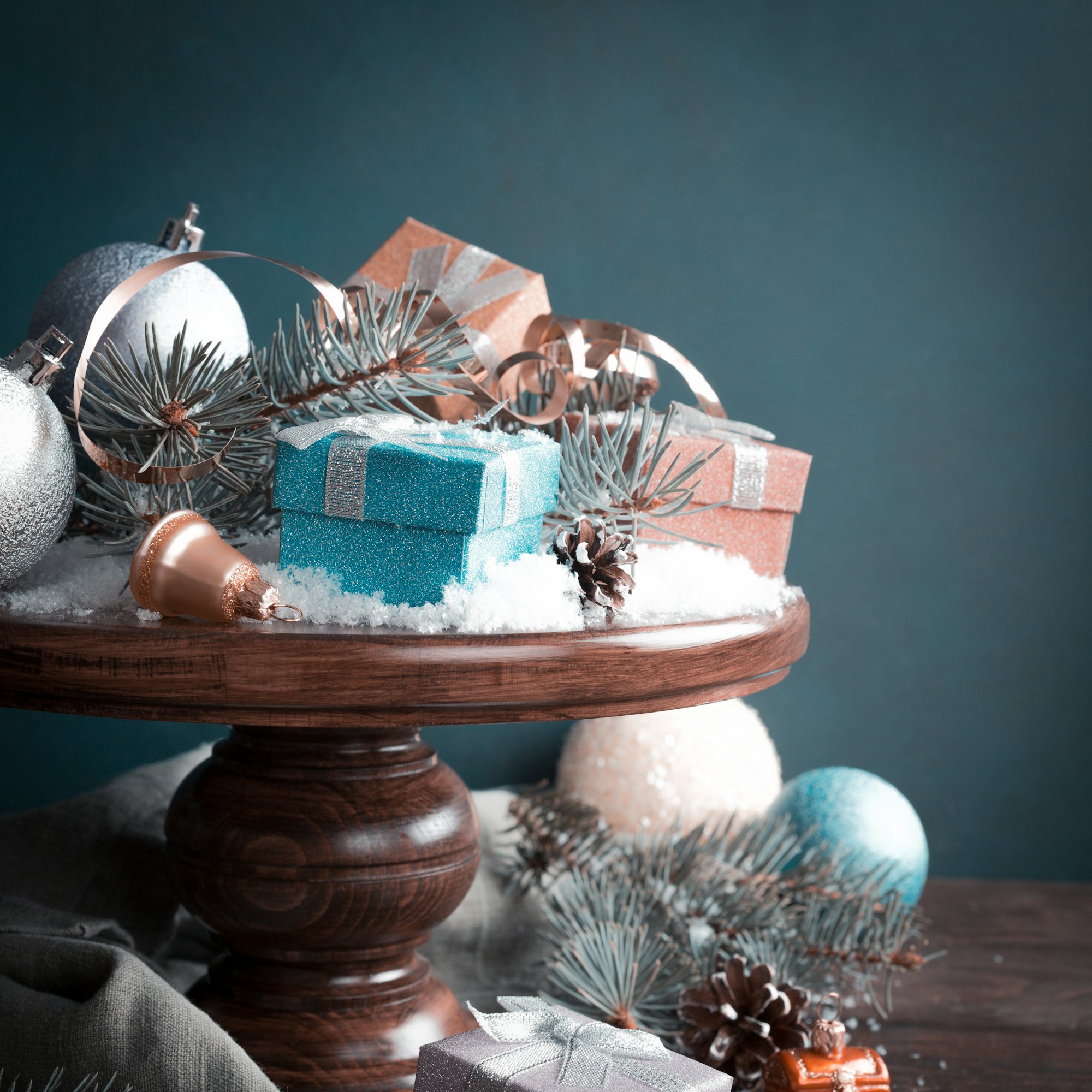 Gifts with christmas decoration on wooden cake stand